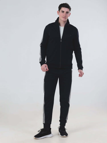 Model showcasing blue Thunder co-ord set, stylish and waterproof joggers and jacket, ideal for men and women.