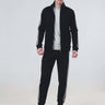 Model wearing Turms Intelligent Cord Set in black, featuring waterproof joggers and a stylish jacket.