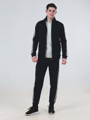 Model wearing Turms Intelligent Cord Set in black, featuring waterproof joggers and a stylish jacket.