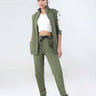 Stylish woman wearing a Turms Intelligent coord set with joggers and jacket, featuring a sporty green design.