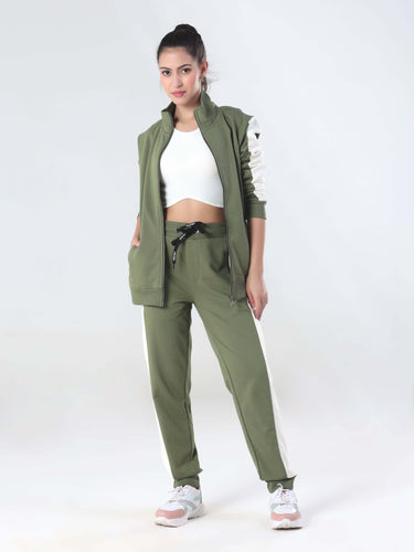 Stylish woman wearing a Turms Intelligent coord set with joggers and jacket, featuring a sporty green design.