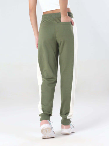 Back view of women's olive green joggers with side white stripes, designed for comfort and style in travel wear.