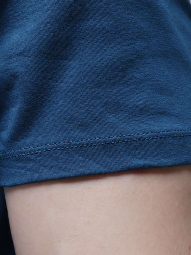 Close-up of a Sea Blue round neck t-shirt sleeve, showcasing premium cotton fabric, tailored fit, and clean stitching for stylish men’s wear.