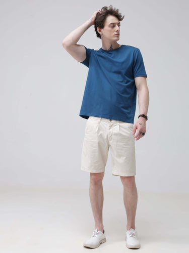 Man wearing Sea Blue round neck t-shirt, tailored fit, premium cotton spandex, standing with hand on head, stylish mens tshirts online.