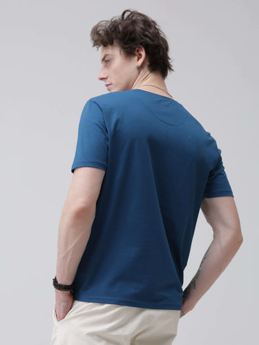 Man wearing Sea Blue round neck t-shirt with tailored fit, stain-proof and odor-resistant, perfect for stylish and trending mens tshirts online.