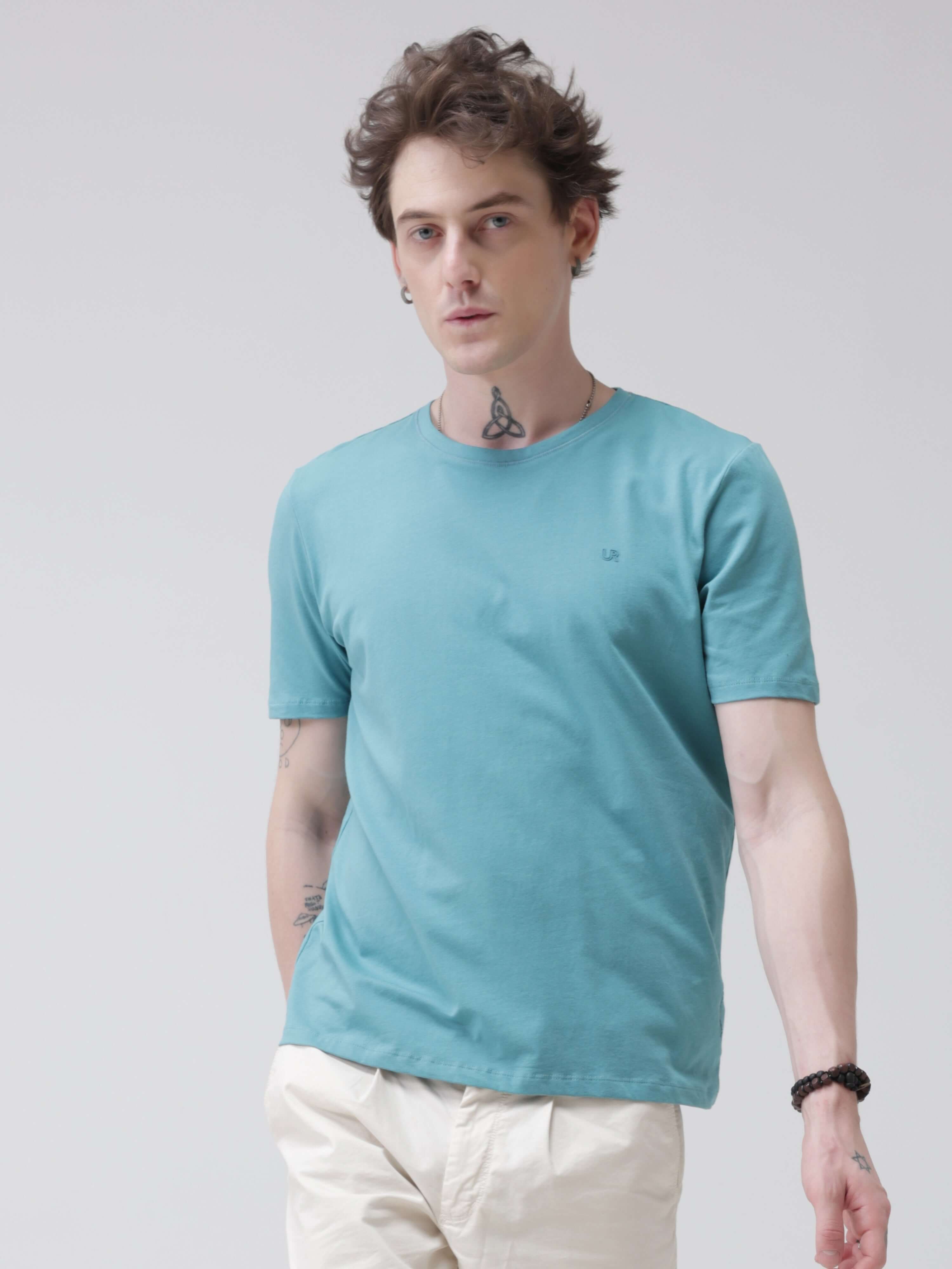 Man wearing turquoise round-neck Turms T-shirt, tailored fit, water-resistant, anti-stain, premium cotton blend, best tshirts for men.