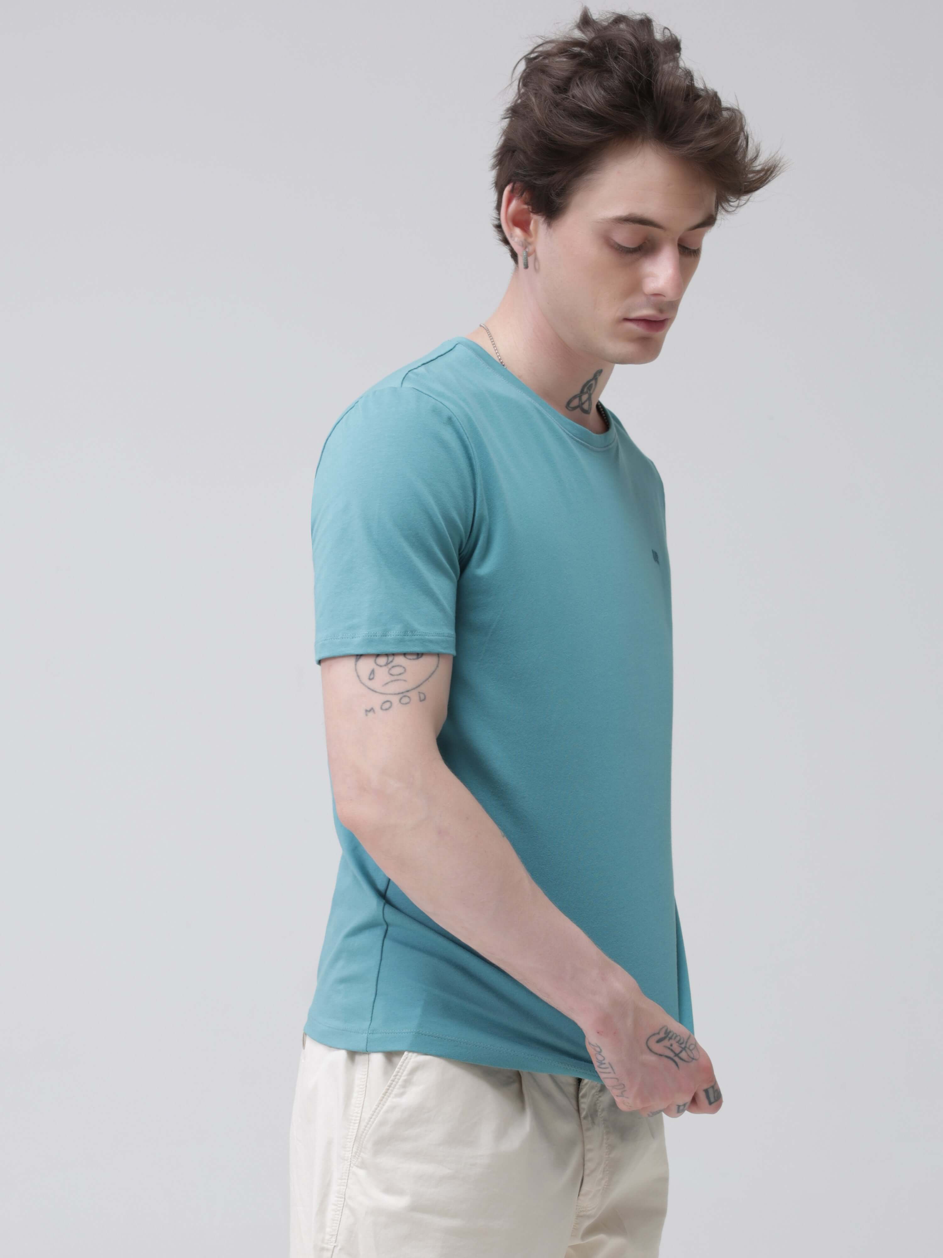 Man wearing a Turms stain-proof, water-resistant round-neck T-shirt in teal, showcasing tailored fit and premium cotton fabric, best for menswear.