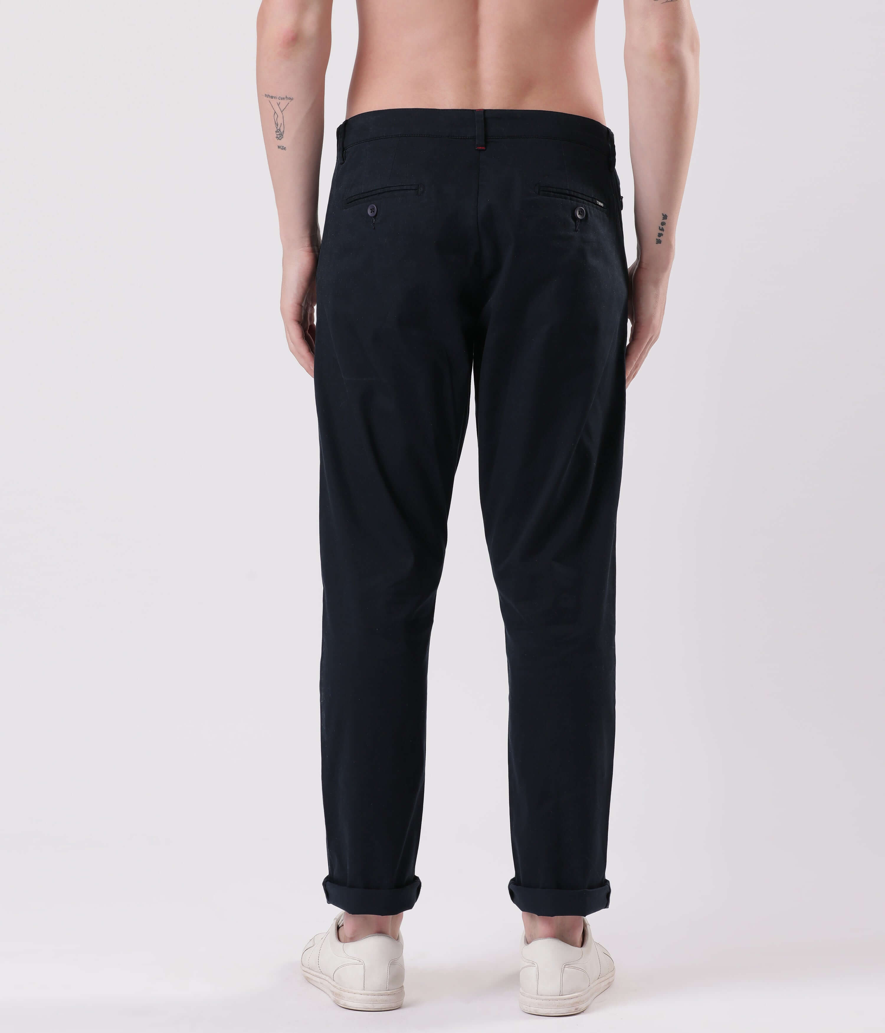 Back view of a model wearing Turms Blue Eyed Chinos, showcasing style and functionality in compact cotton and spandex.