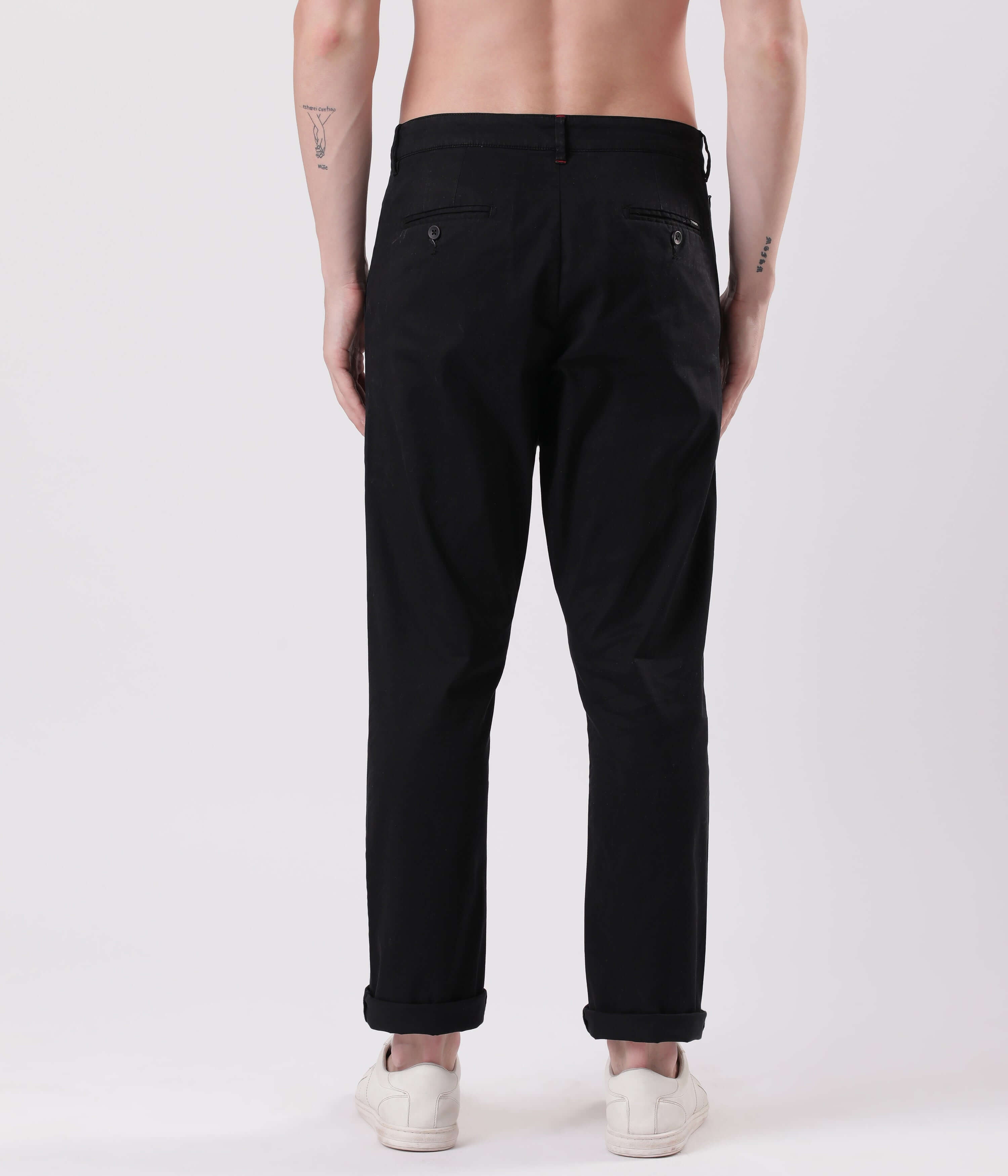 Back view of a man wearing Turms Black Sea Chino, showcasing style and stretchability in luxury fashion.