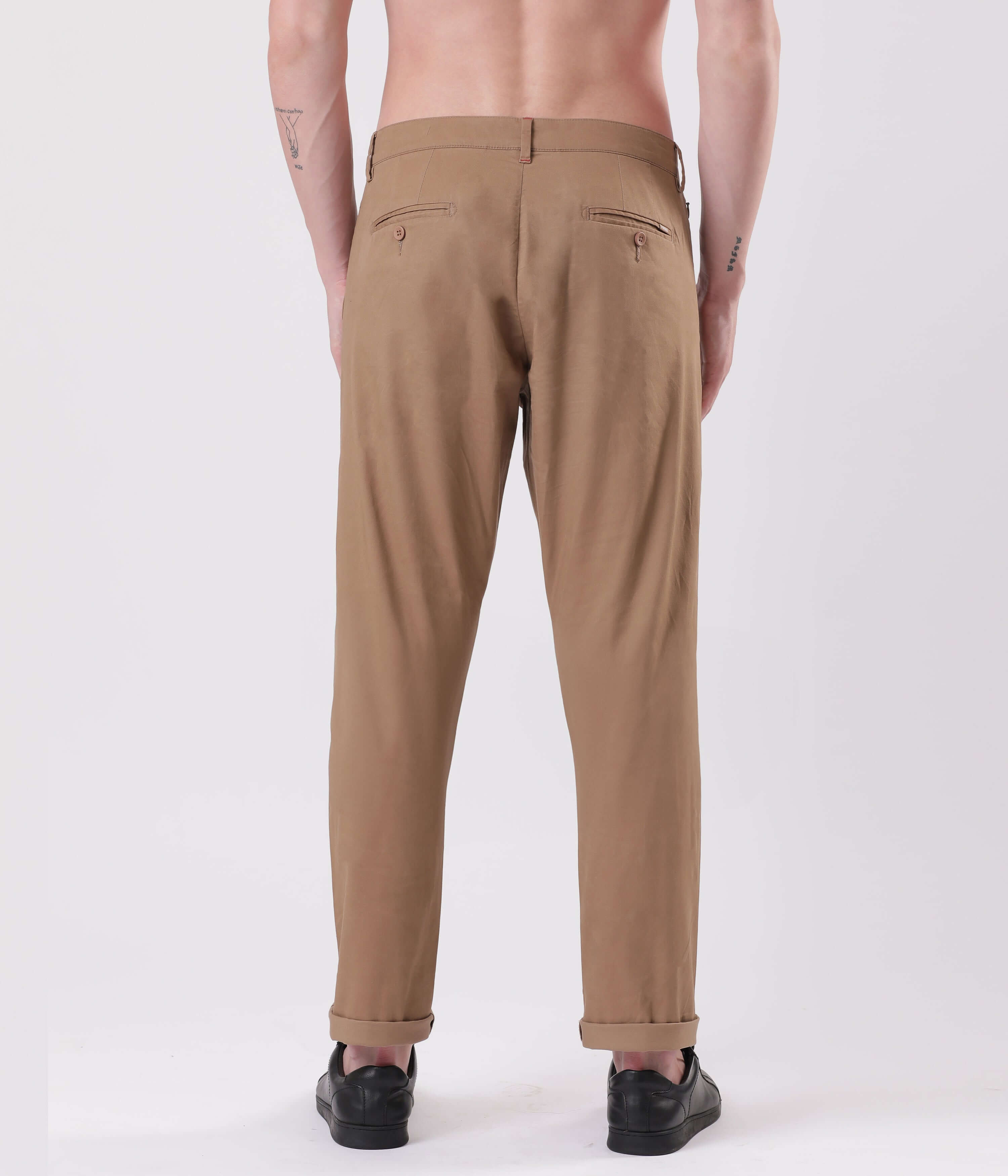 Back view of a man wearing Turms Dessert Mirage Chino pants in a stylish tan color.