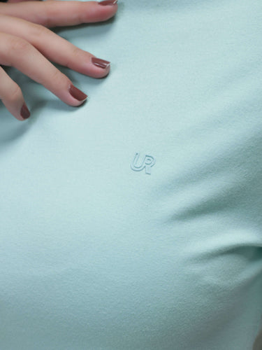 Close-up of Aqua stain-proof and odor-resistant Turms T-shirt in round neck design, showcasing premium white cotton fabric and anti-microbial properties.