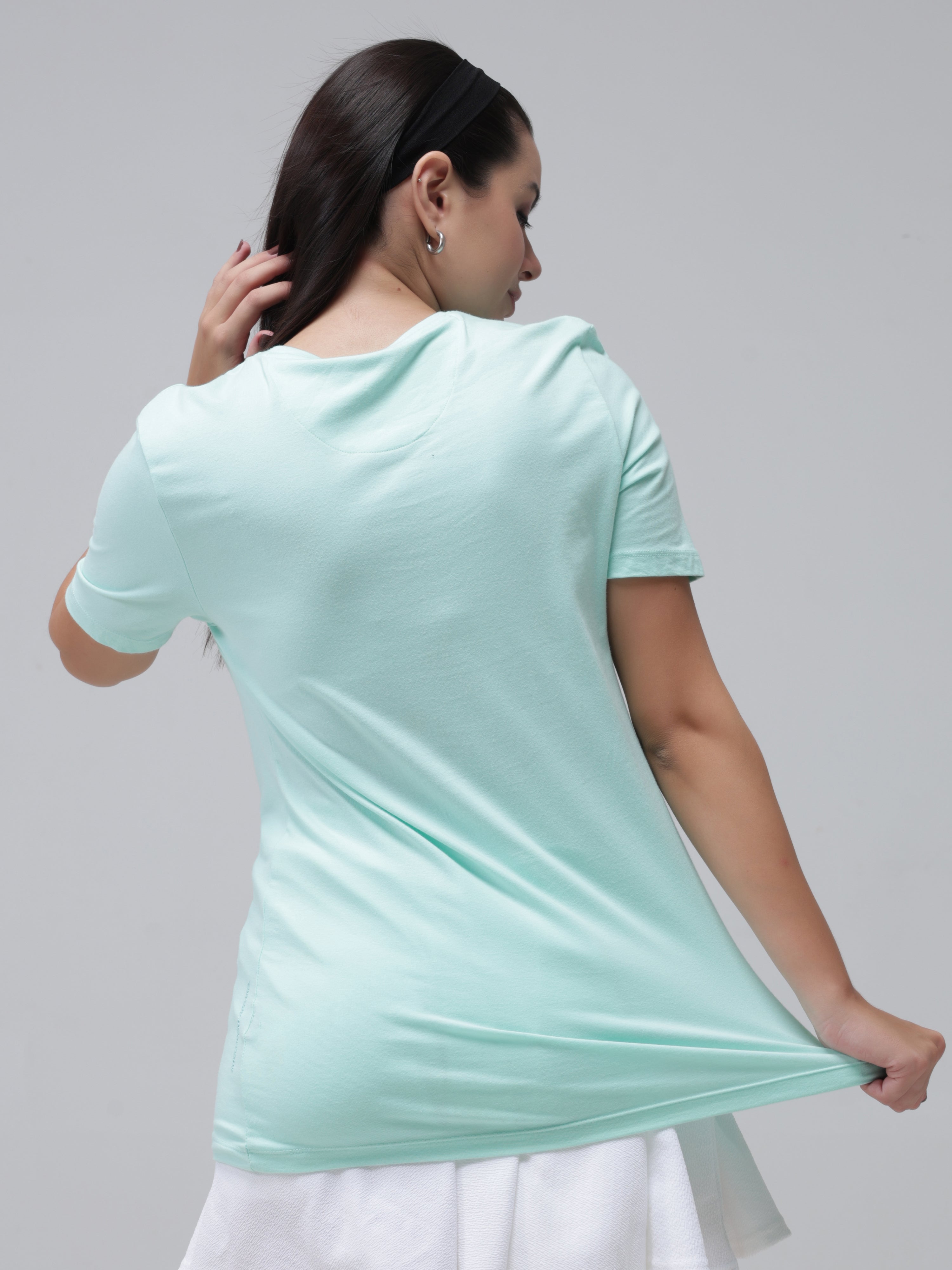 Woman wearing Aqua round-neck Turms t-shirt, showcasing the back. Made from 95% Premium Cotton and 5% Spandex, stain-proof and odor-resistant.