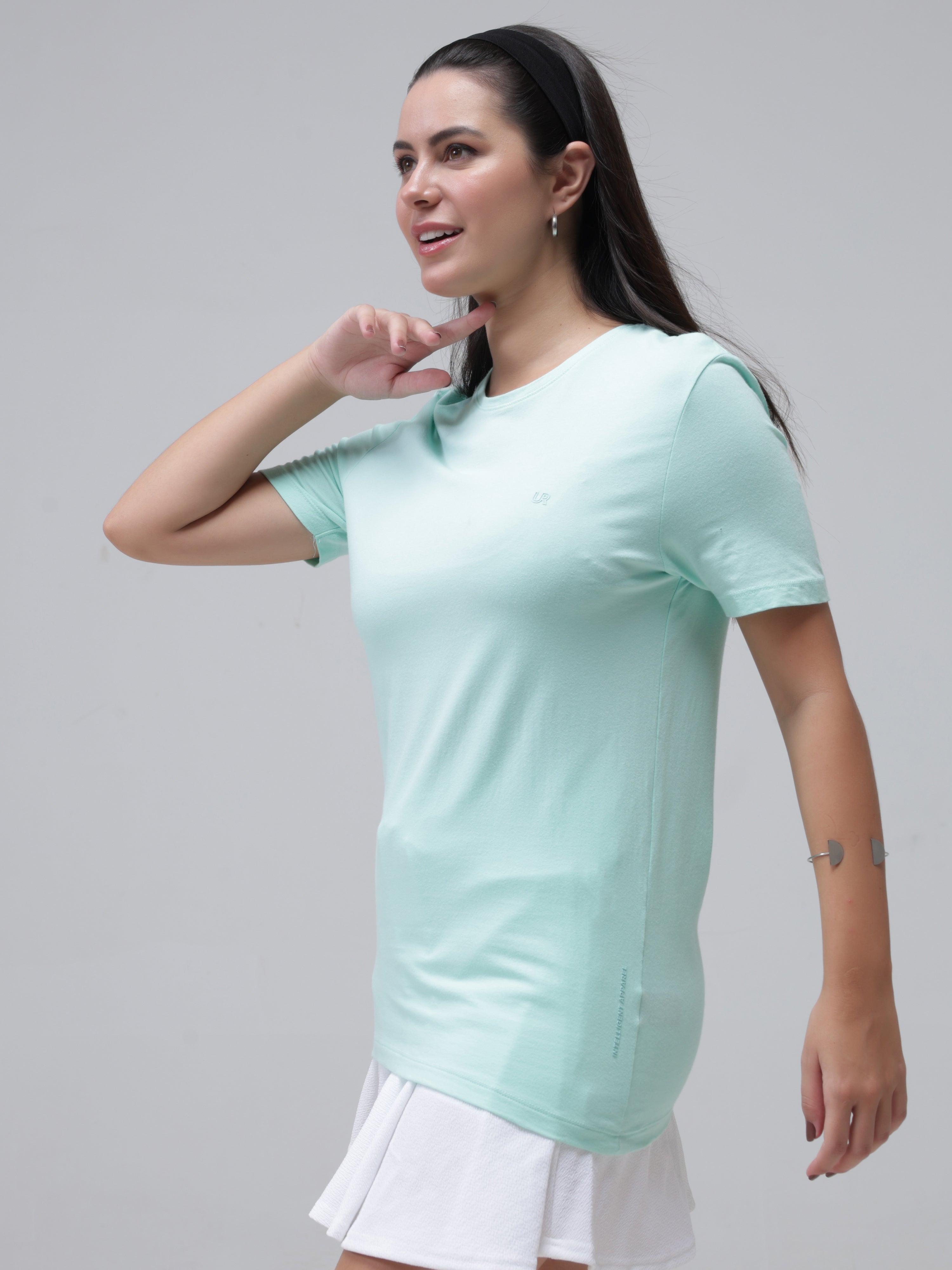 Woman wearing a stylish light aqua round-neck t-shirt, perfect for casual wear and made from premium cotton with stain-proof and odor-resistant features.