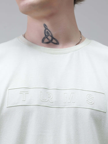 Close-up of person wearing a Lime Enigma Turms T-shirt showcasing anti-stain, anti-odor, and stretchable fabric features.