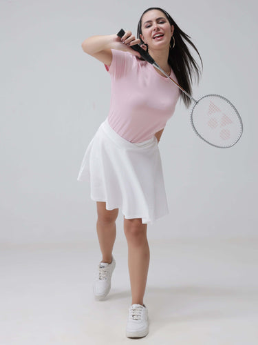 Woman in pink round-neck T-shirt playing badminton, wearing stain-proof and odor-resistant Turms intelligent apparel, tailored fit, trending women's fashion
