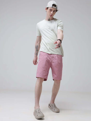 Man wearing Lime Enigma Turms T-shirt with anti-stain and anti-odour technology, paired with pink shorts and beige shoes.