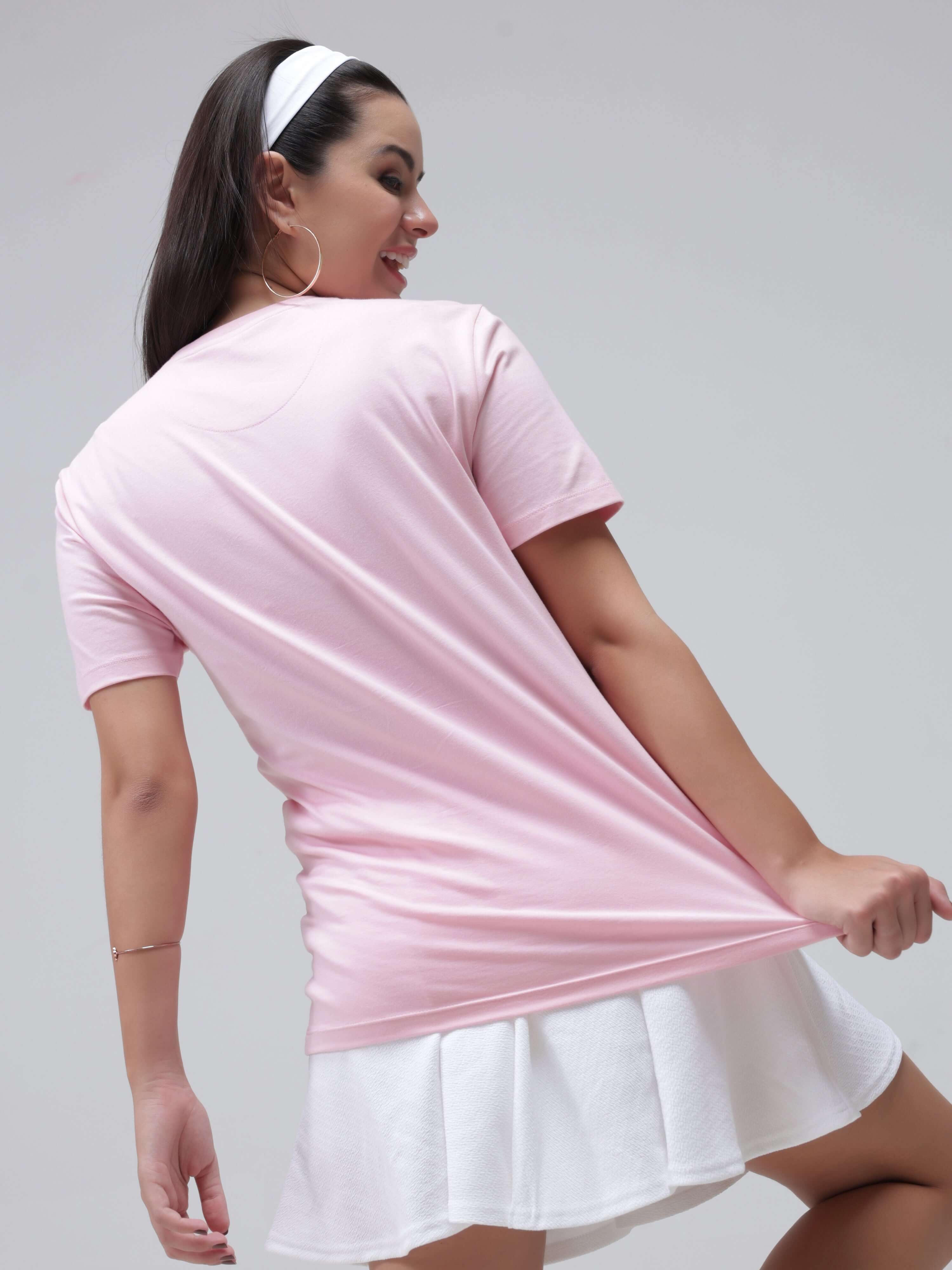 Woman wearing Mystic Orchid Turms T-shirt in pink, showcasing anti stain, anti odour, stretchable features, perfect for everyday wear