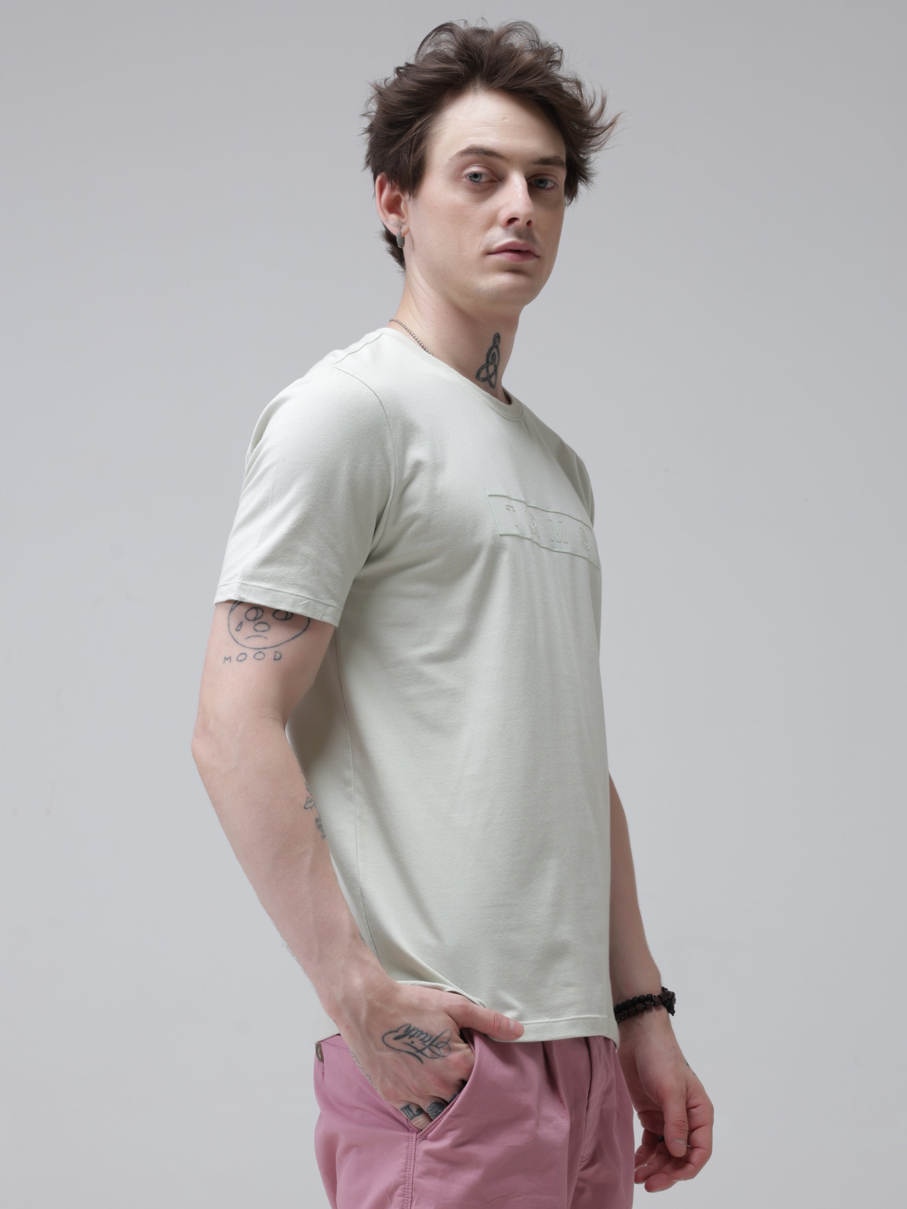 Man wearing anti-stain, anti-odor, stretchable Lime Enigma Turms T-shirt with tailored fit, round neck, in light green, showcasing intelligent apparel.
