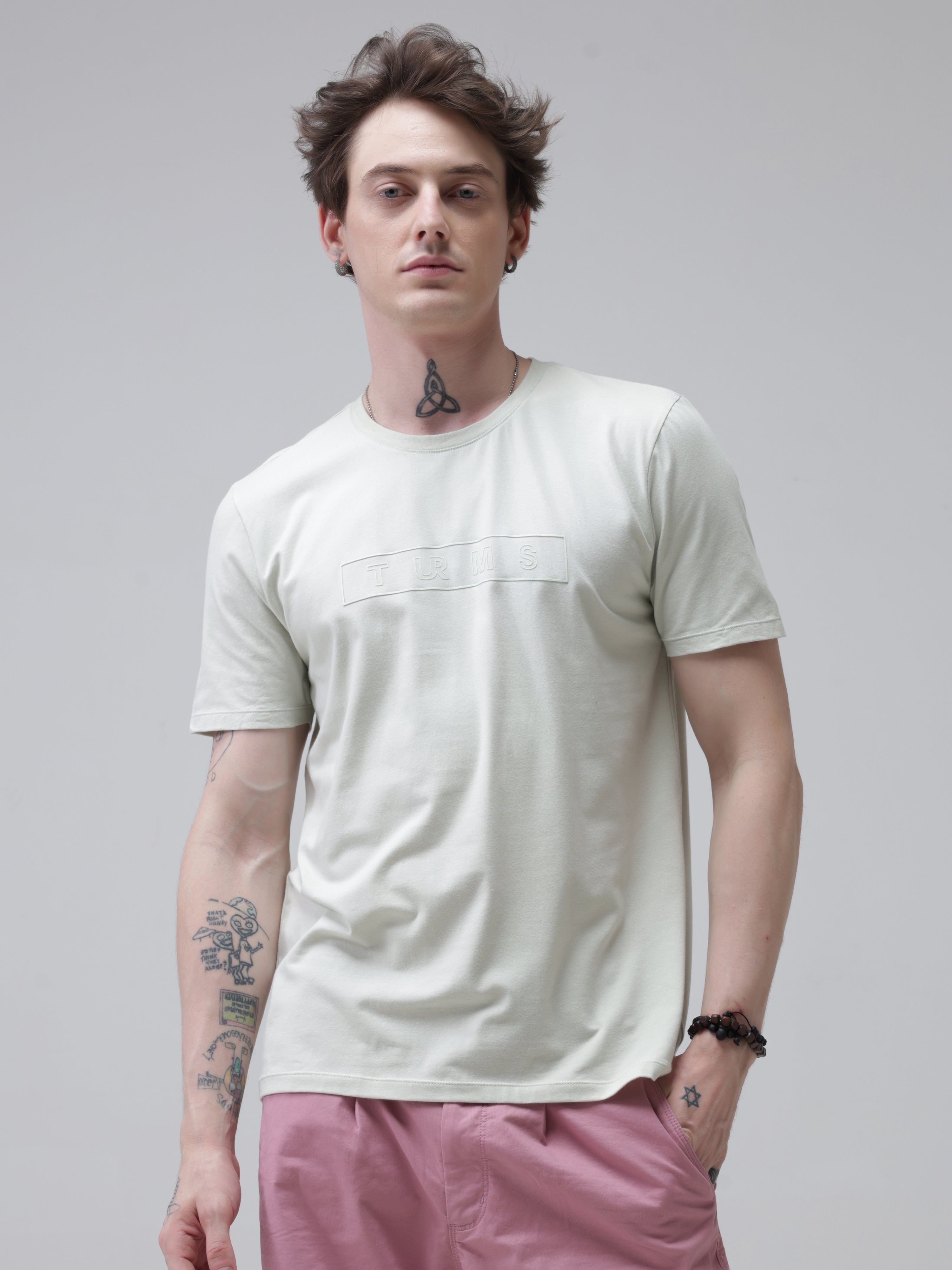 Man wearing Lime Enigma Turms T-shirt with anti-stain and anti-odour features, showcasing stain-proof, stretchable intelligent apparel.