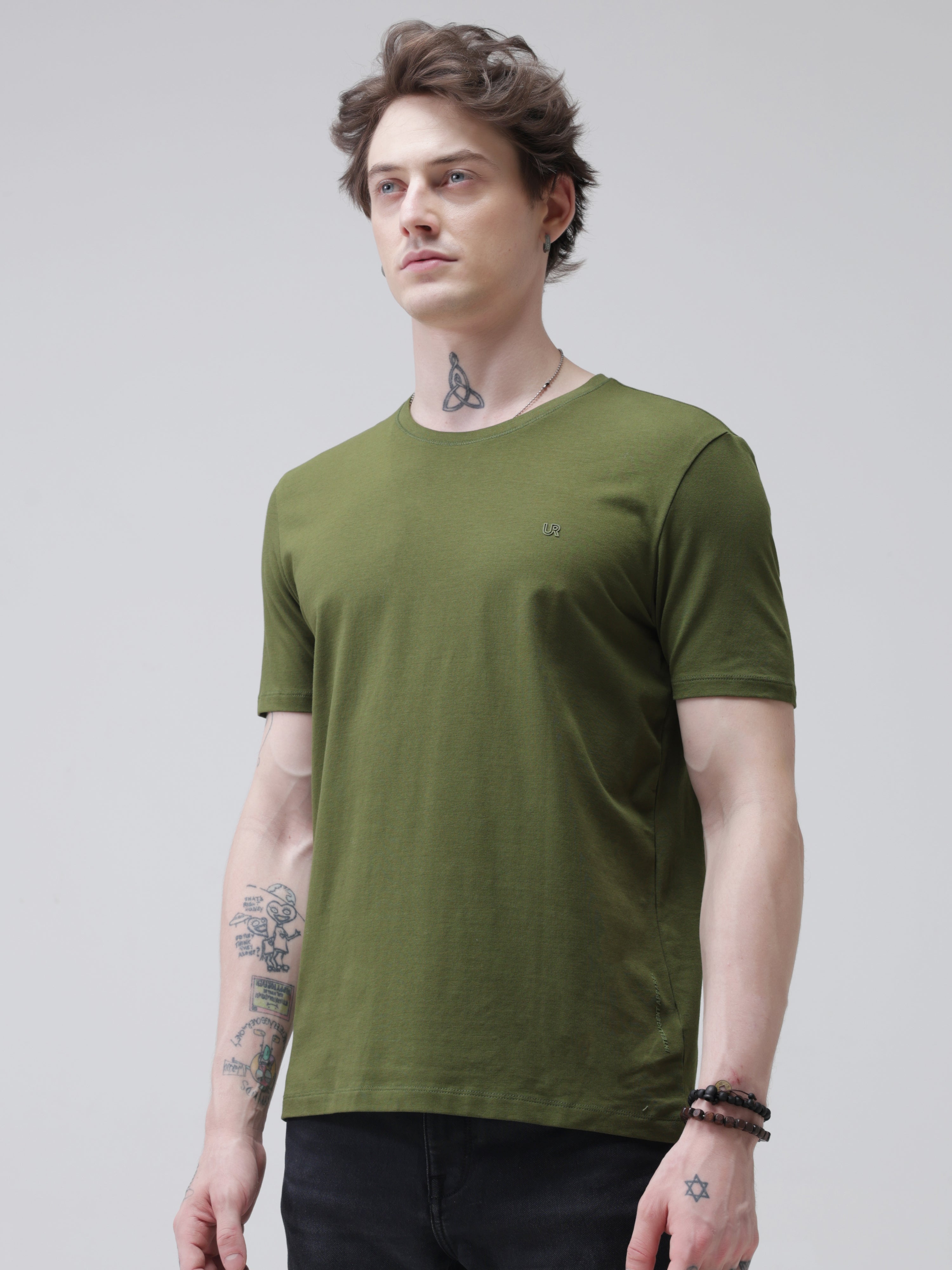 Man wearing a green round-neck Turms T-shirt, stain-proof, odor-resistant, best polo tshirt for men, menswear, premium cotton, water resistant.