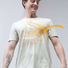 Man smiling as liquid spills onto his stain-proof Turms T-shirt, showcasing its anti-stain, anti-odor, and stretchable properties.