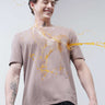 Man wearing a stain-proof Dusky Maroon Turms T-shirt, smiling as liquid spills on his shirt. Round neck, tailored fit, stylish and odor-resistant.