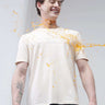 Model smiling while water-based stain repels off Soft Peach Turms T-shirt; anti-stain, anti-odor, stretchable intelligent apparel.
