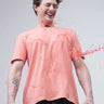 Man wearing Sunset Spice round-neck Turms T-shirt with stain-proof and anti-odour properties, laughing as liquid spills on the shirt.