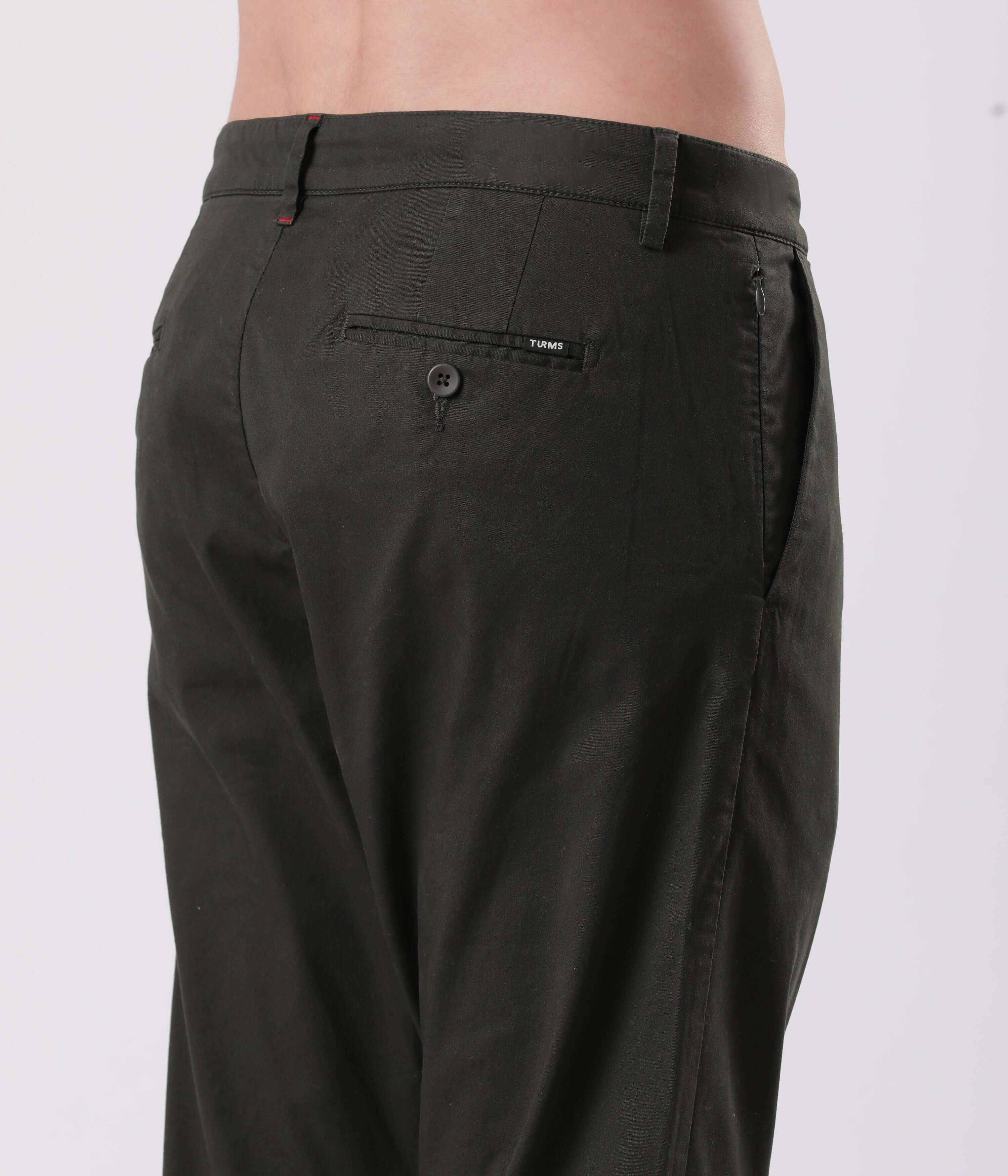 Sage Olive Chino by Turms, showcasing durable stitching and a stylish back pocket design.