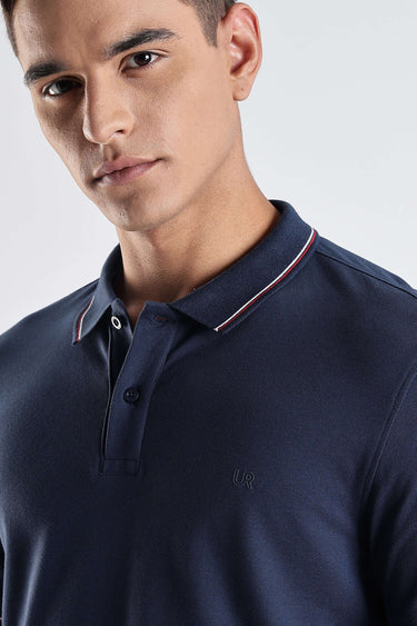 Close-up of a man wearing the Orion Blue premium cotton polo tshirt with stylish collar, showcasing comfort and quality.