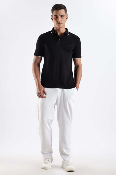 Model wearing Black Primal cotton polo t-shirt, premium and stylish, showcasing comfort and innovative design for men.