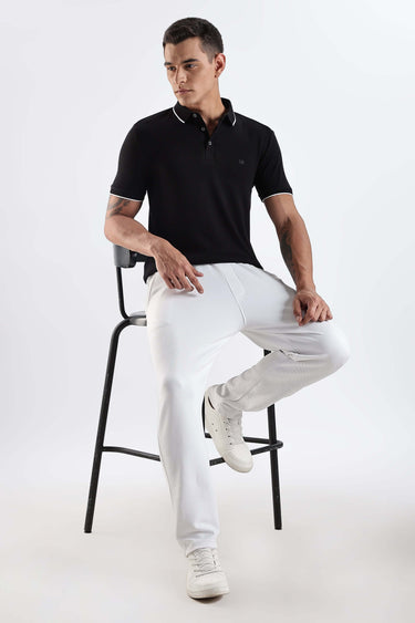 Man wearing Black Primal cotton polo t-shirt with premium style, comfort, and anti-odour features.