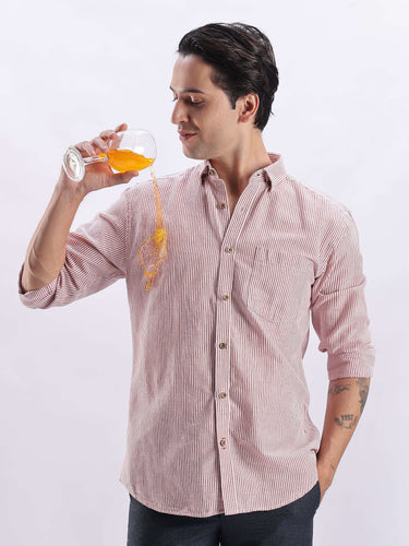 Man in Scarlet Knight shirt from Turms Intelligent Apparel, enjoying a drink, showcasing premium design and comfort.