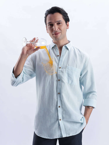 Man wearing the Moon Mist shirt while pouring a drink, showcasing premium linen shirt features from Turms Intelligent Apparel.