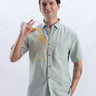 Fern Green linen shirt from turms intelligent apparel showing anti-stain and water-proof features in action.