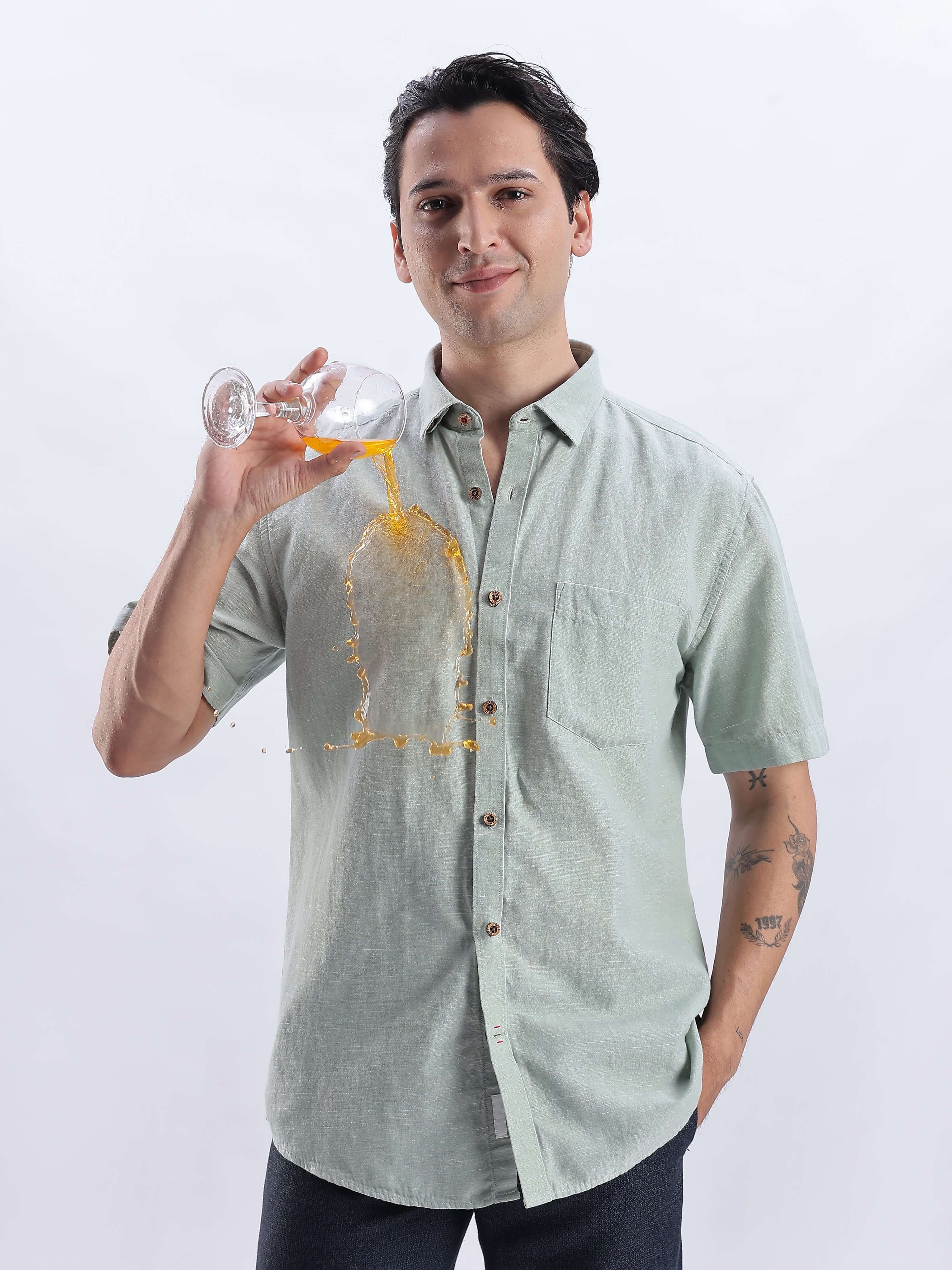 Fern Green linen shirt from turms intelligent apparel showing anti-stain and water-proof features in action.