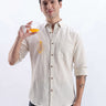 Dune Drift premium linen shirt from turms intelligent apparel worn by a man holding a glass with juice.