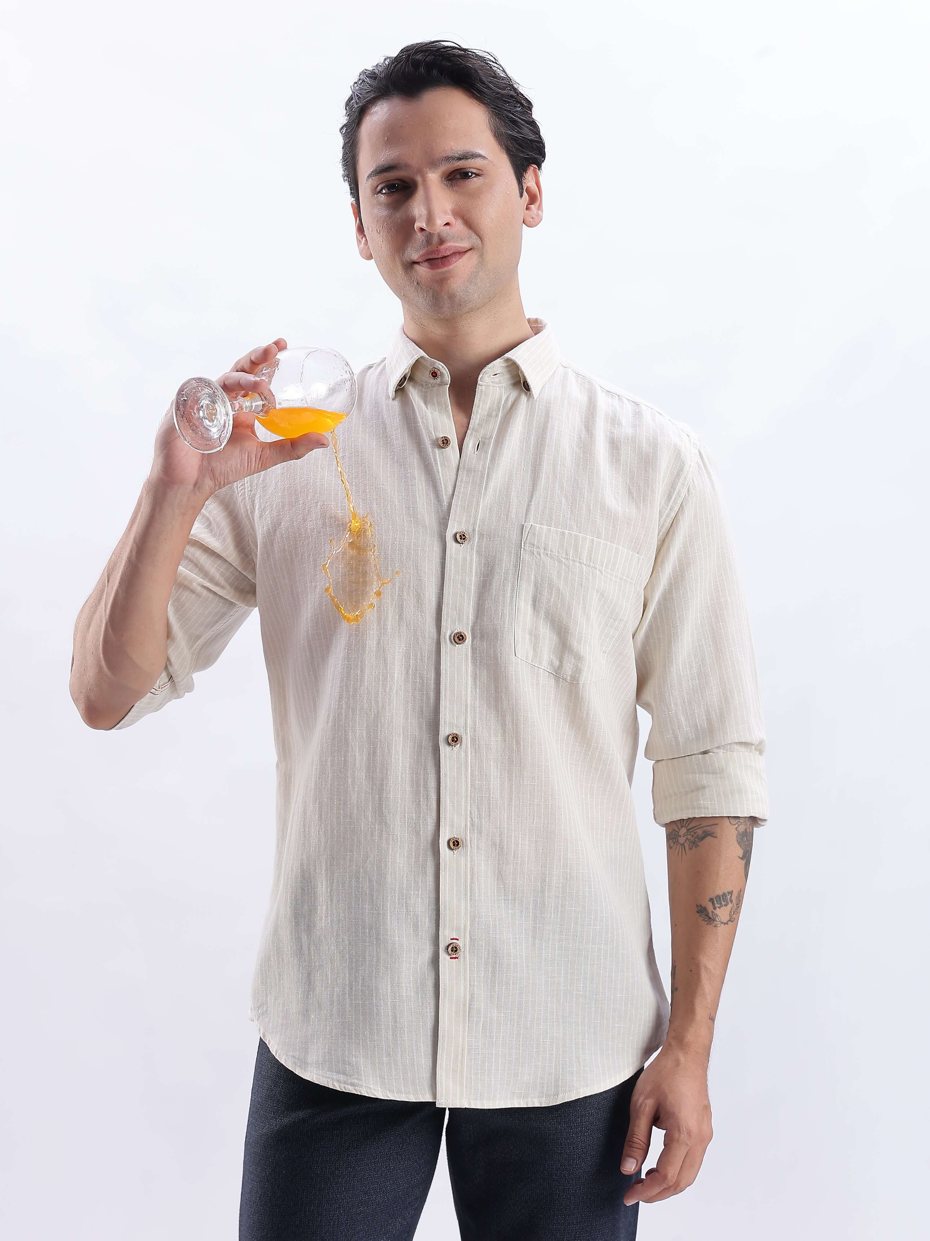Dune Drift premium linen shirt from turms intelligent apparel worn by a man holding a glass with juice.