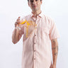 Man wearing a blushy peach linen shirt from Turms Intelligent Apparel, showcasing its anti-stain, water-proof features.