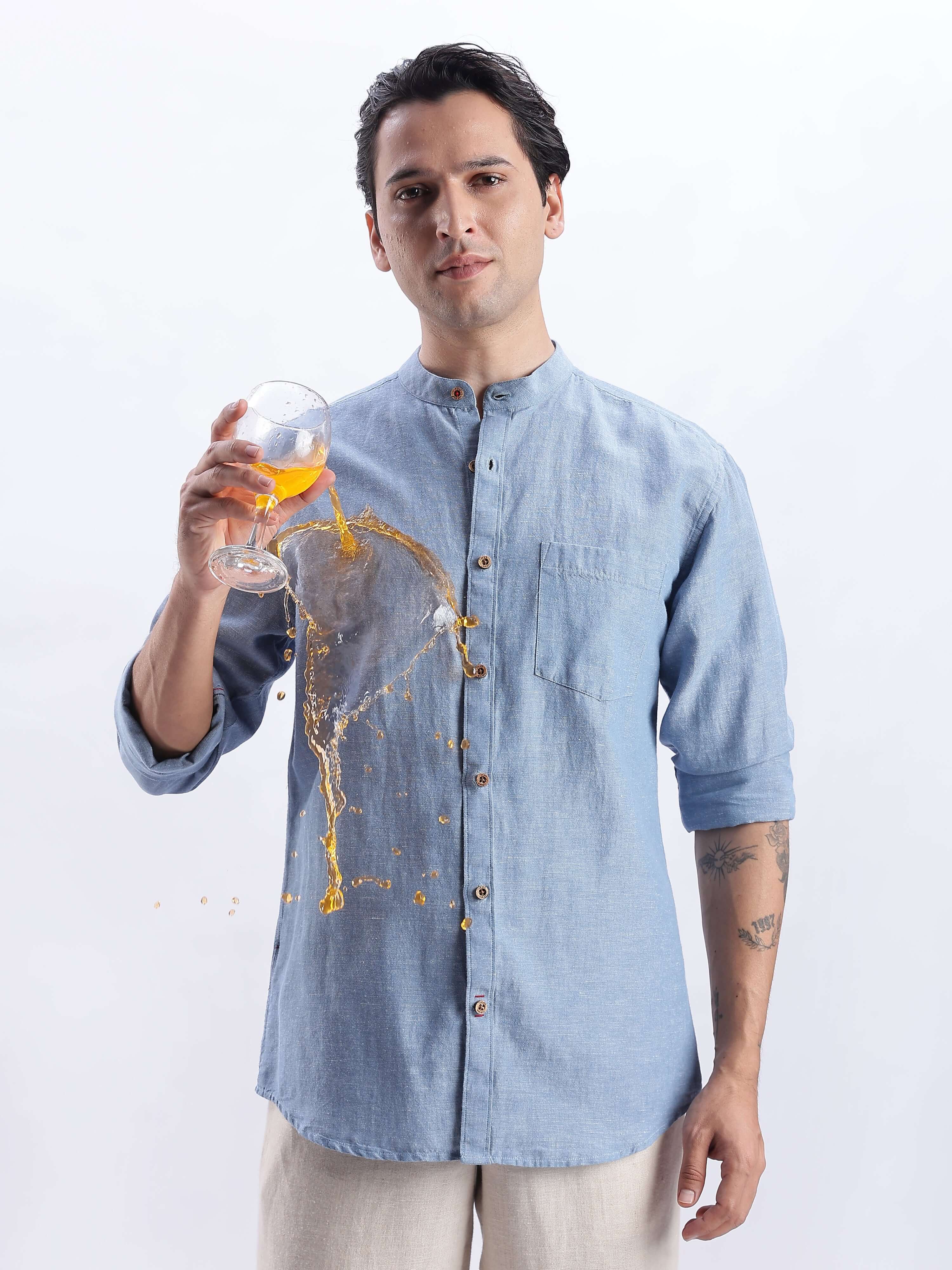 Man wearing Onxy Teal 2.0 linen shirt showcasing its water proof, anti odour, and anti stain features.