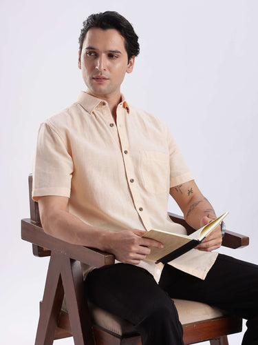 Man wearing an Opalescent Sand linen shirt from Turms Intelligent Apparel, showcasing style and functionality.