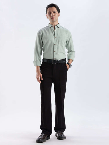 Canary Green shirt model wearing premium linen shirt from turms intelligent apparel in black trousers