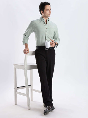 Man wearing a premium Canary Green linen shirt from Turms Intelligent Apparel, showcasing style and functionality.