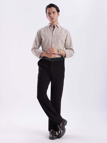 Irish Cream premium linen shirt from turms intelligent apparel worn by a man in stylish black trousers.