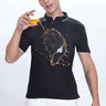 Black Primal black polo tshirt showcasing water proof and anti-stain features while worn by a man holding a drink.