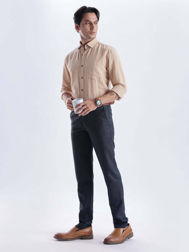 Man in an Iced Mokha premium linen shirt from Turms Intelligent Apparel, holding a cup with stylish dark pants.