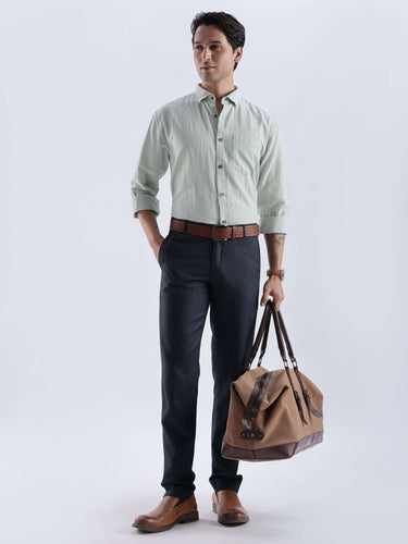 Pistachio Green premium linen shirt from Turms Intelligent Apparel with stylish brown belt and bag.