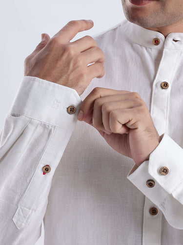 A close-up of a man wearing the White Wolf 2.0 linen shirt, showcasing premium buttons and elegant design.