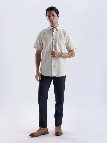 Sandy Glow linen shirt worn by a man, showcasing its premium quality in a stylish outfit.