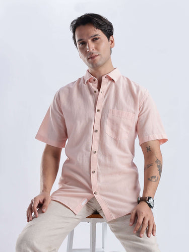 Blushy peach linen shirt from turms intelligent apparel showcasing breathable, anti-odour, anti-stain features.